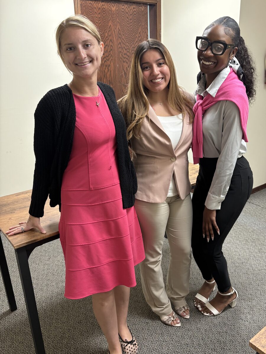 Three Intuitive Career Solutions team members smiling together in the office